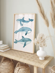 Three illustrative blue whales in watercolour style on a white background, arranged vertically, in an alternate framed mockup