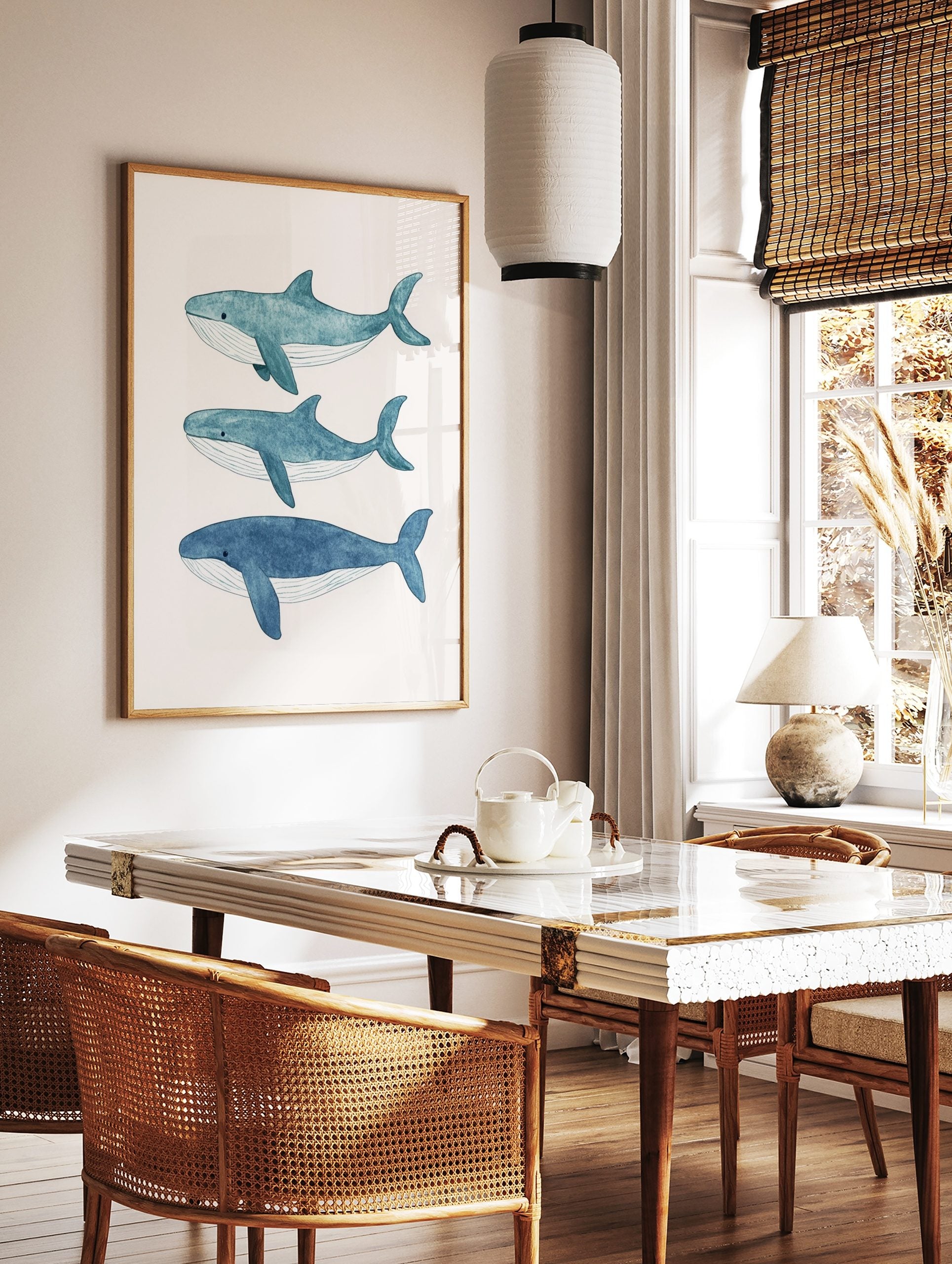 Three blue watercolour whales swimming horizontally on a light background, arranged vertically, in a styled room mockup