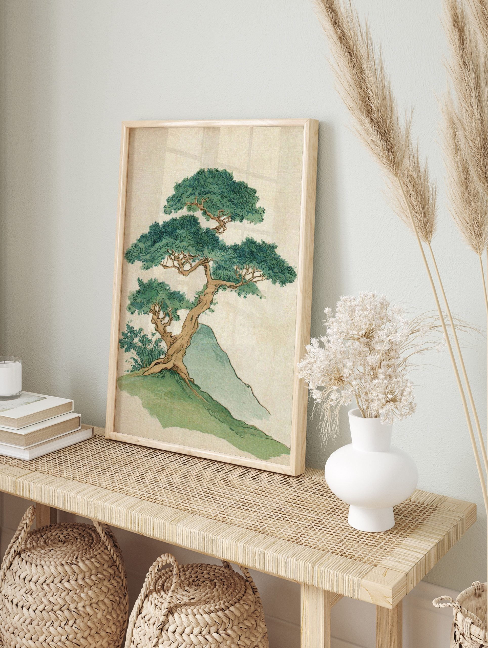 Illustrative print of a gnarled bonsai-style tree with dense green leaves on a grassy hill, in an alternate framed mockup