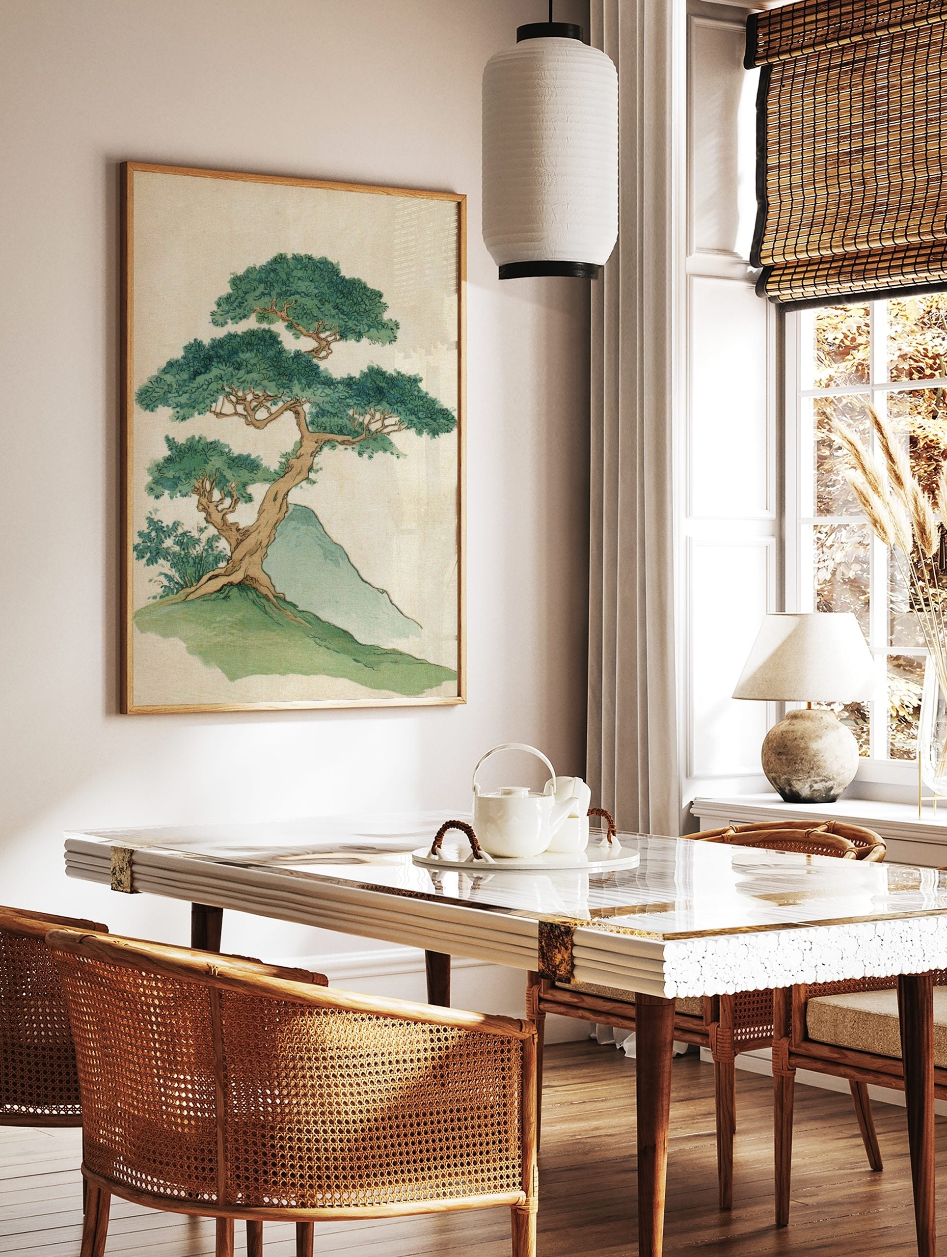 Illustrative print of a gnarled bonsai-style tree with dense green leaves on a grassy hill next to, in a styled room mockup