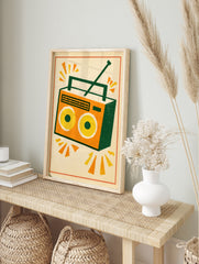 Retro boombox radio illustration in orange, yellow and green on a cream background, in an alternate framed mockup