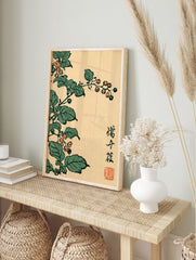 Botanical Japanese woodblock style print featuring orange berries and green leaves on a cream, in an alternate framed mockup