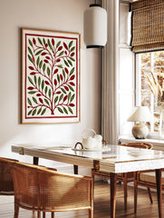 Stylised botanical illustration with green leaves and red berries inside a red border on a cream, in a styled room mockup