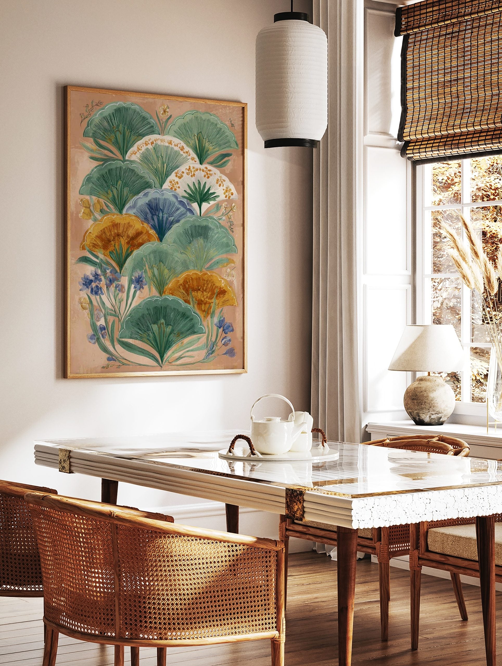 Illustrative botanical wall art with layered green, orange, and blue fan-shaped leaves on a peach, in a styled room mockup
