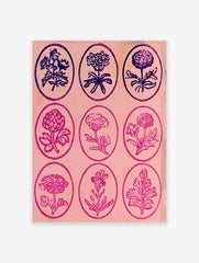 Vintage-style grid of nine botanical flower illustrations in oval frames on a pink background, floral wall art print