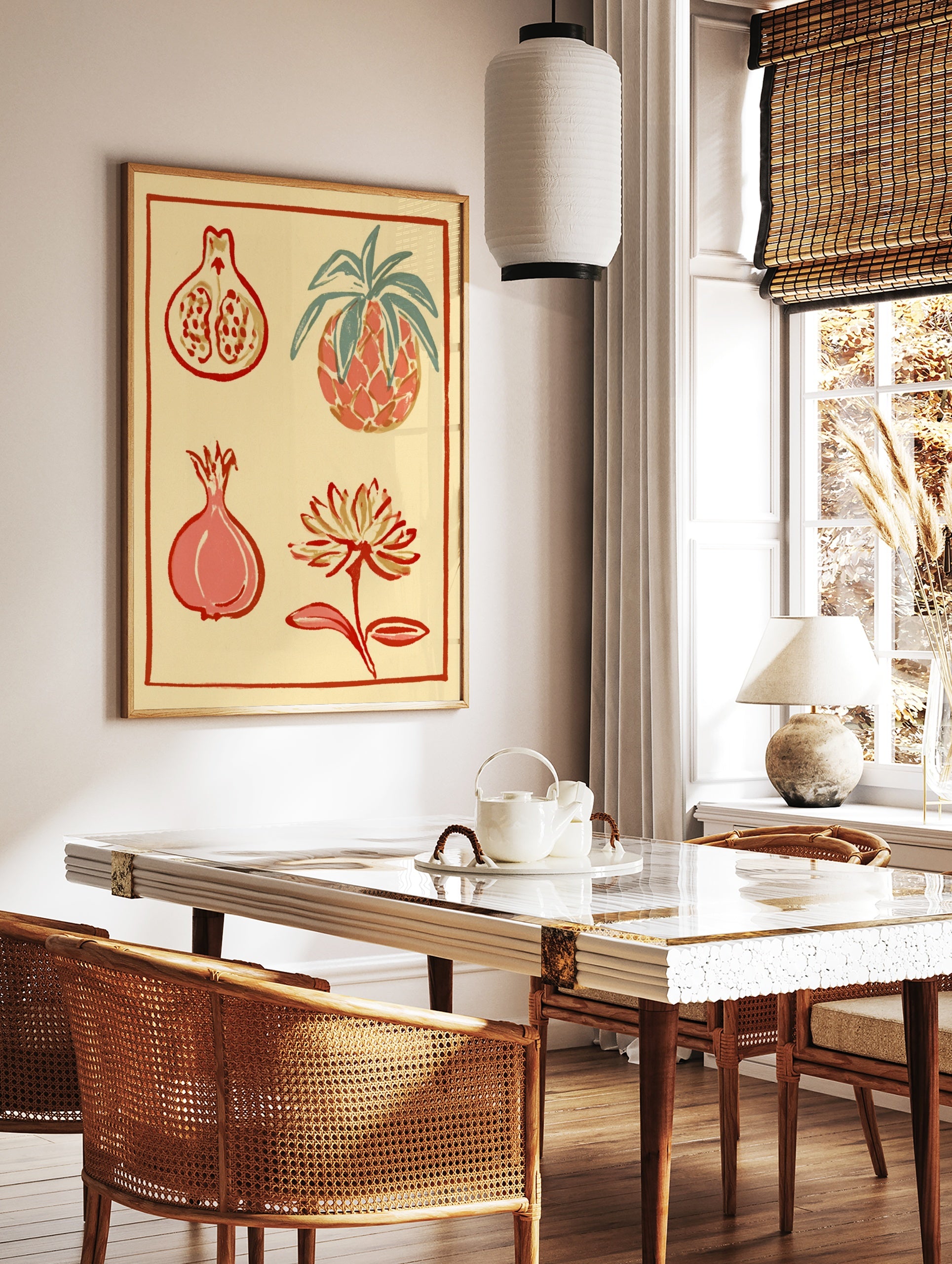 Botanical wall art illustration featuring a pineapple, pomegranate halves, and a flower in red and, in a styled room mockup