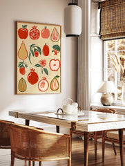 Botanical fruit illustration with red pomegranates, apples, and pears in a retro block-print style, in a styled room mockup