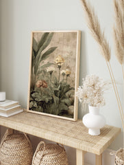 Botanical garden art print with large green leaves, yellow and muted pink flowers, on a, in an alternate framed mockup
