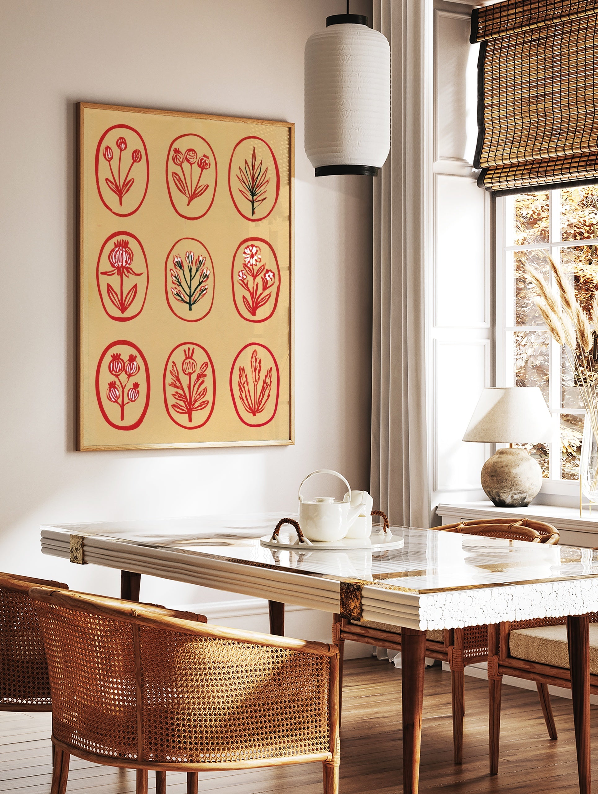 Botanical grid wall art print featuring nine red floral and leaf illustrations inside oval frames, in a styled room mockup