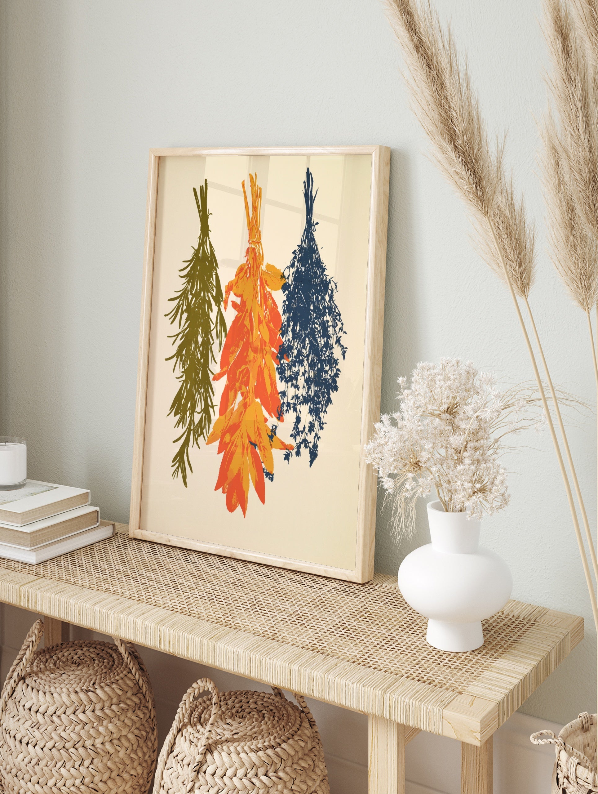 Three bundles of hanging herbs in olive green, orange, and navy blue illustration on an, in an alternate framed mockup