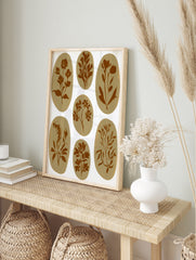 Seven brown botanical illustrations in oval shapes on a white background, in an alternate framed mockup