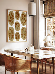 Seven brown botanical illustrations in oval shapes on a white background, in a styled room mockup