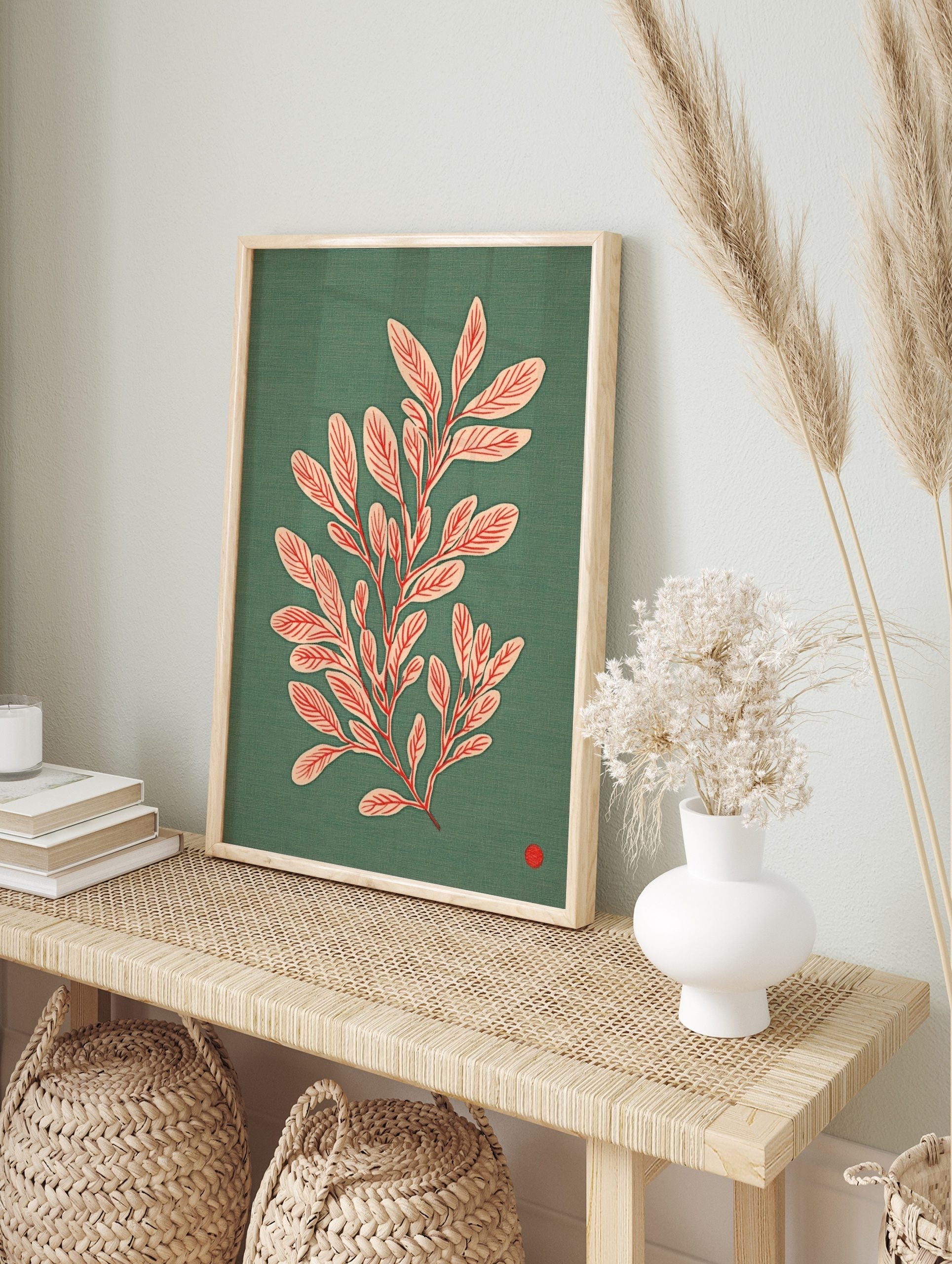 Botanical illustration of a leafy plant with pale pink leaves and red veins on a teal, in an alternate framed mockup