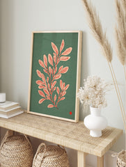 Botanical illustration of a leafy plant with pale pink leaves and red veins on a teal, in an alternate framed mockup
