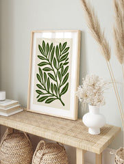 Botanical leaf illustration art print with deep green foliage on a cream background, in an alternate framed mockup