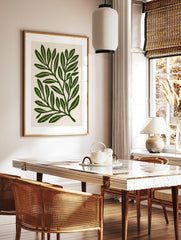 Botanical leaf illustration art print with deep green foliage on a cream background, in a styled room mockup