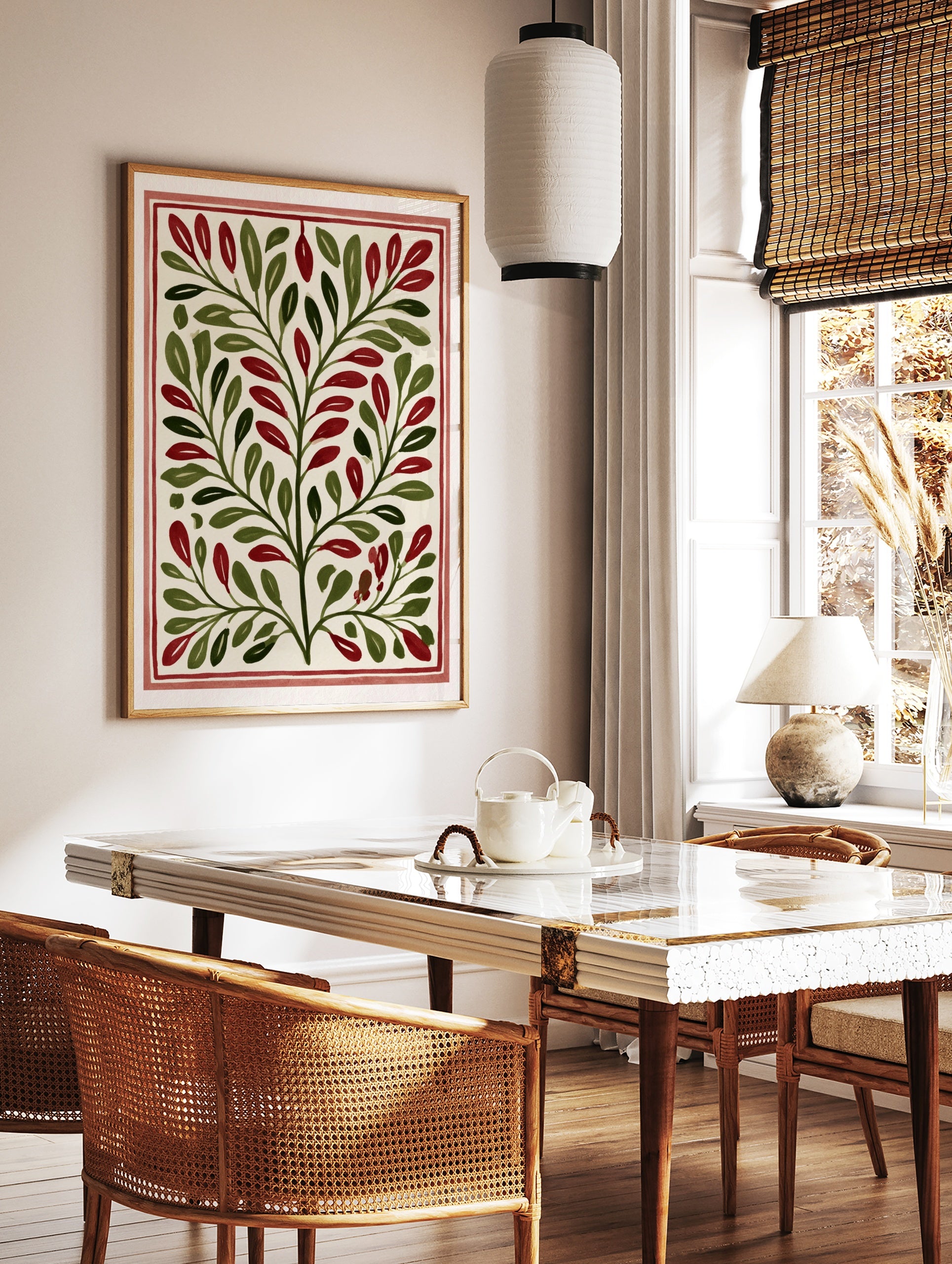 Botanical illustration with symmetrical green leaves and red berries on a cream background, framed, in a styled room mockup