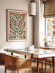 Botanical illustration with symmetrical green leaves and red berries on a cream background, framed, in a styled room mockup