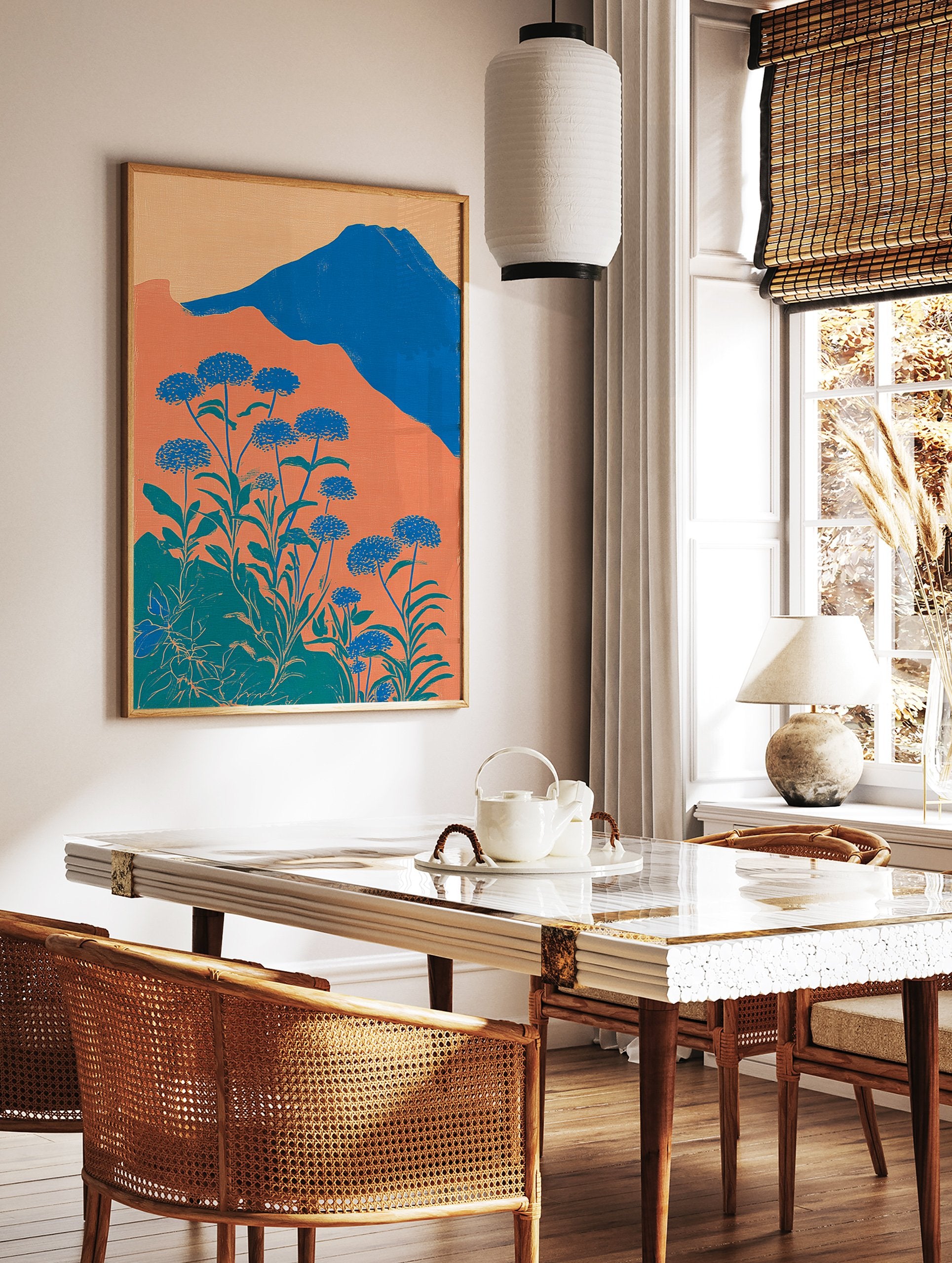 Illustrative botanical wall art with blue flowers, green leaves, orange hills, and a blue mountain under a light orange sky. - Image 2