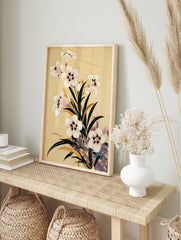 Botanical illustration of white flowers with dark centres and green leaves on a tan background, in an alternate framed mockup