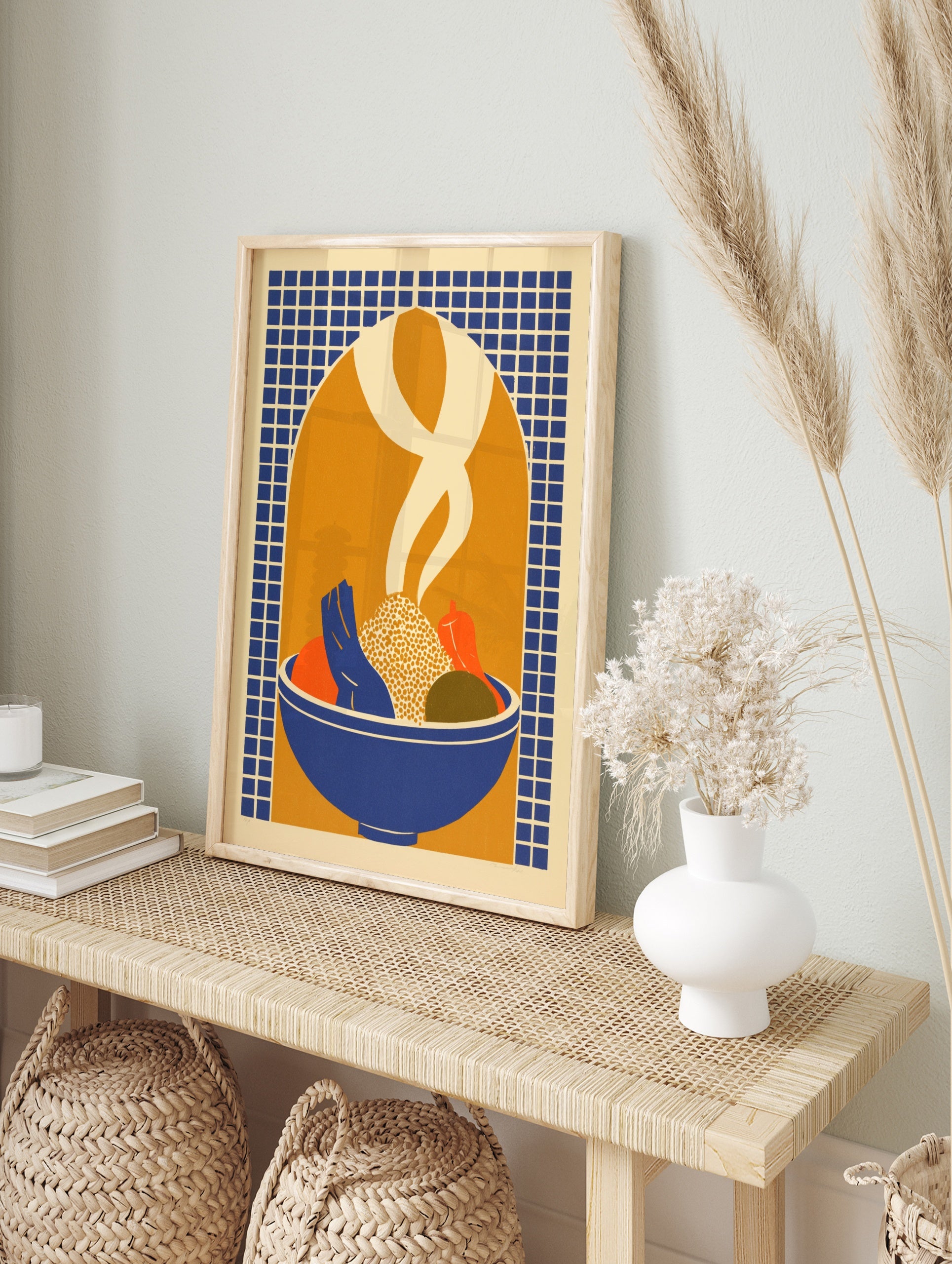 Illustrative print of a bowl of food with vegetables and rising steam against a blue grid and, in an alternate framed mockup