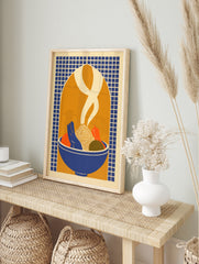 Illustrative print of a bowl of food with vegetables and rising steam against a blue grid and, in an alternate framed mockup