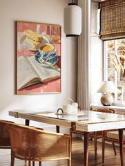 Breakfast still life poster featuring a cup of coffee, an open book, pastries, and a glass of water on a pink table. - Image 2
