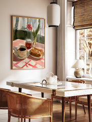 Watercolour illustration of a pink tulip, coffee, and buttered toast on a red and white checkered, in a styled room mockup