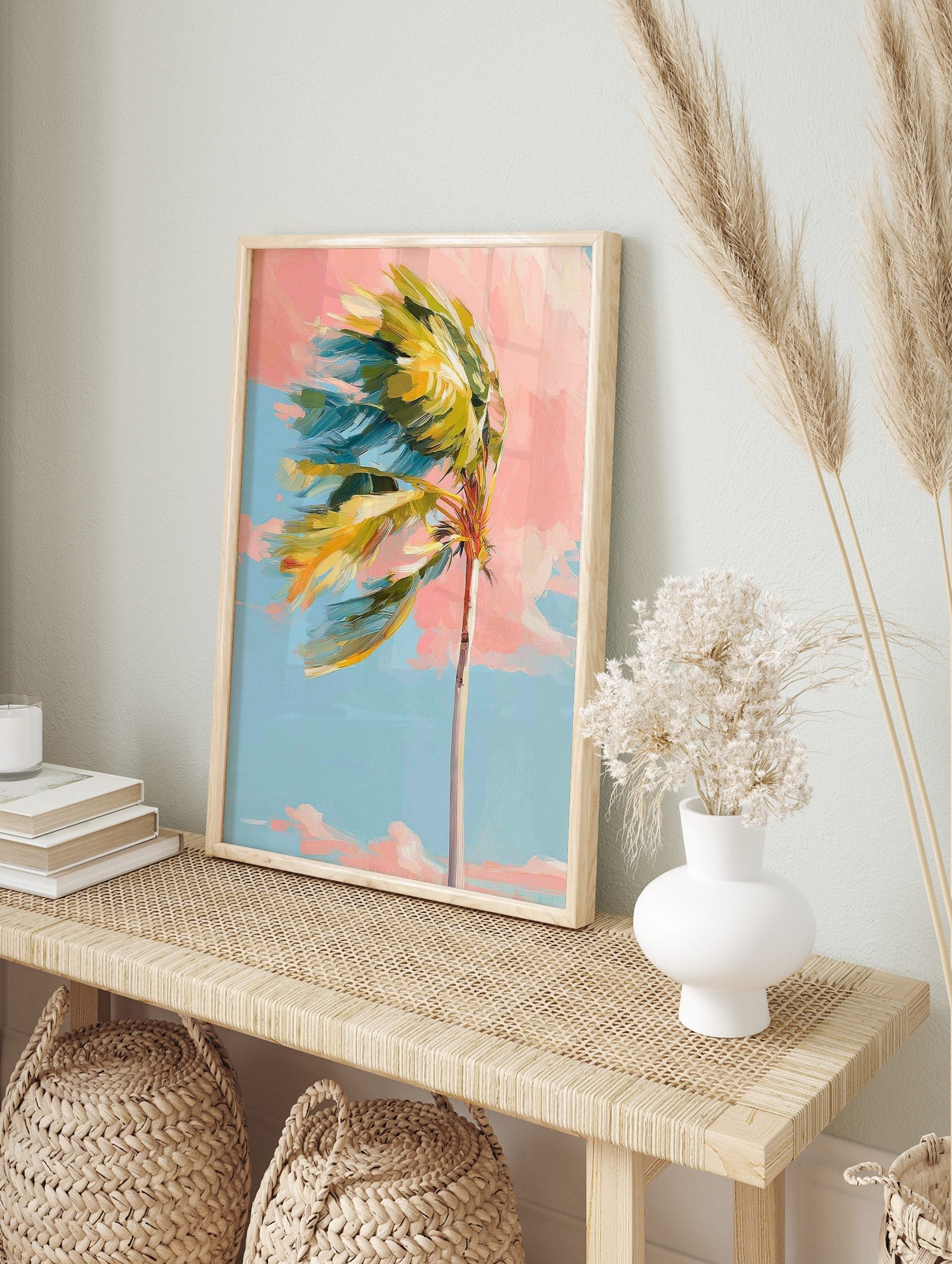 Impressionistic palm tree with green and yellow leaves blowing left against a pink and blue, in an alternate framed mockup