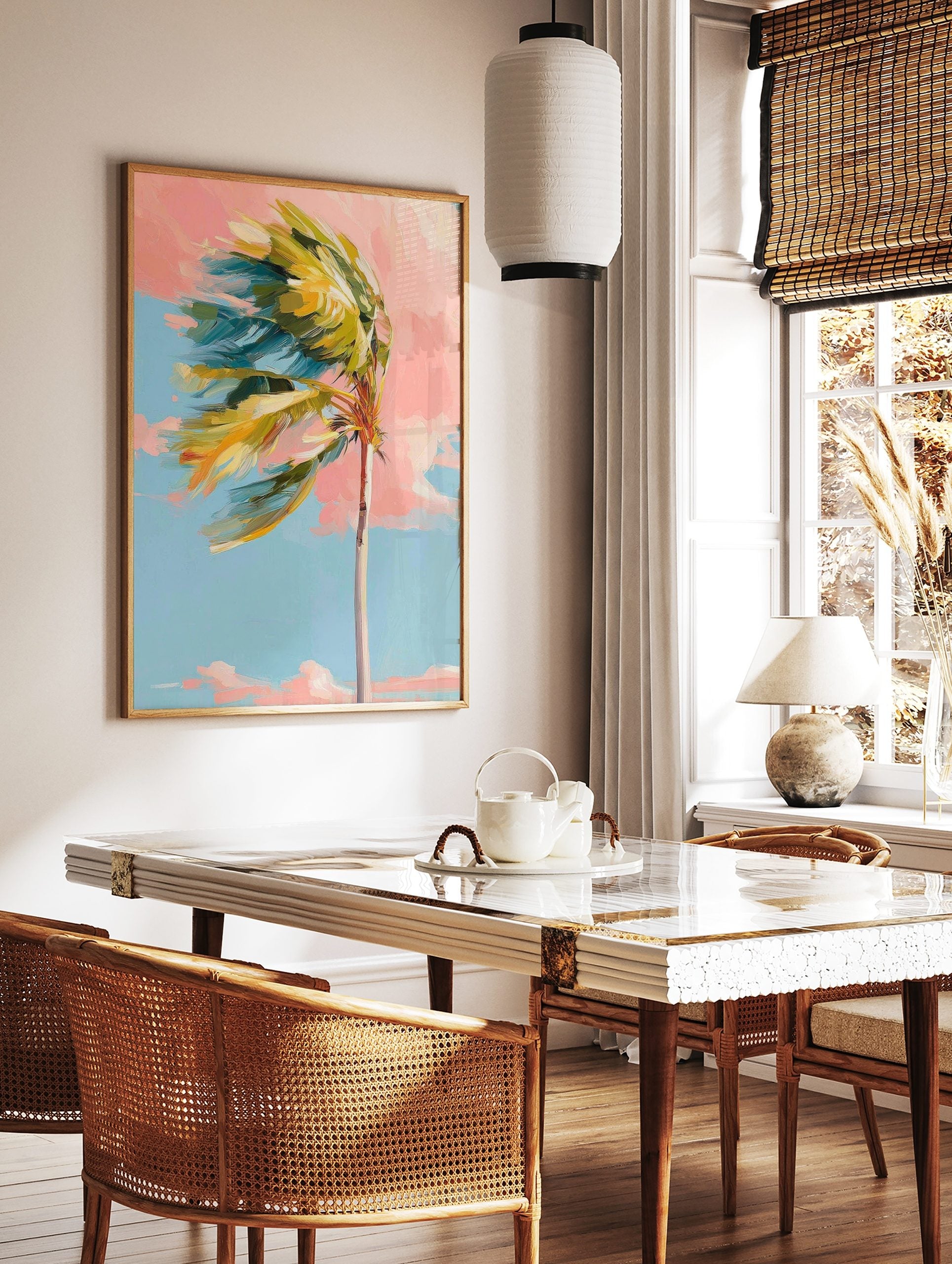 Impressionistic palm tree with green and yellow leaves blowing left against a pink and blue sky, in a styled room mockup