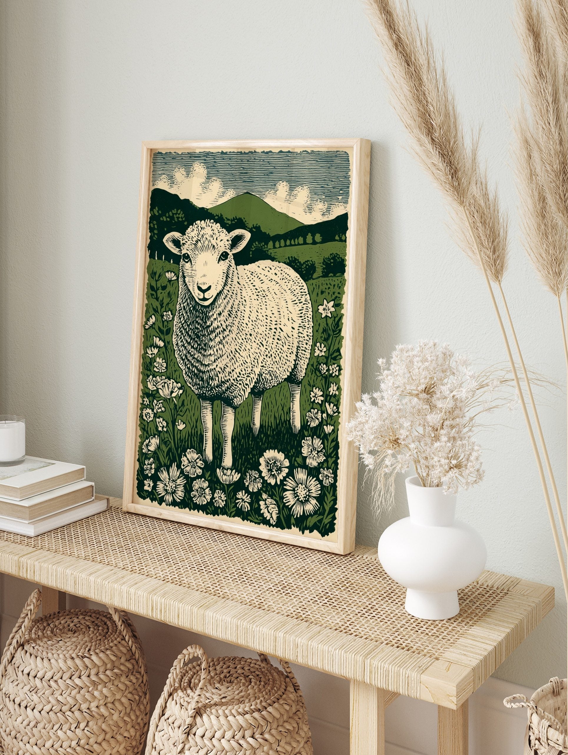Illustrative British lamb in a wildflower meadow with green hills and striped sky in linocut, in an alternate framed mockup