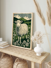 Illustrative British lamb in a wildflower meadow with green hills and striped sky in linocut, in an alternate framed mockup