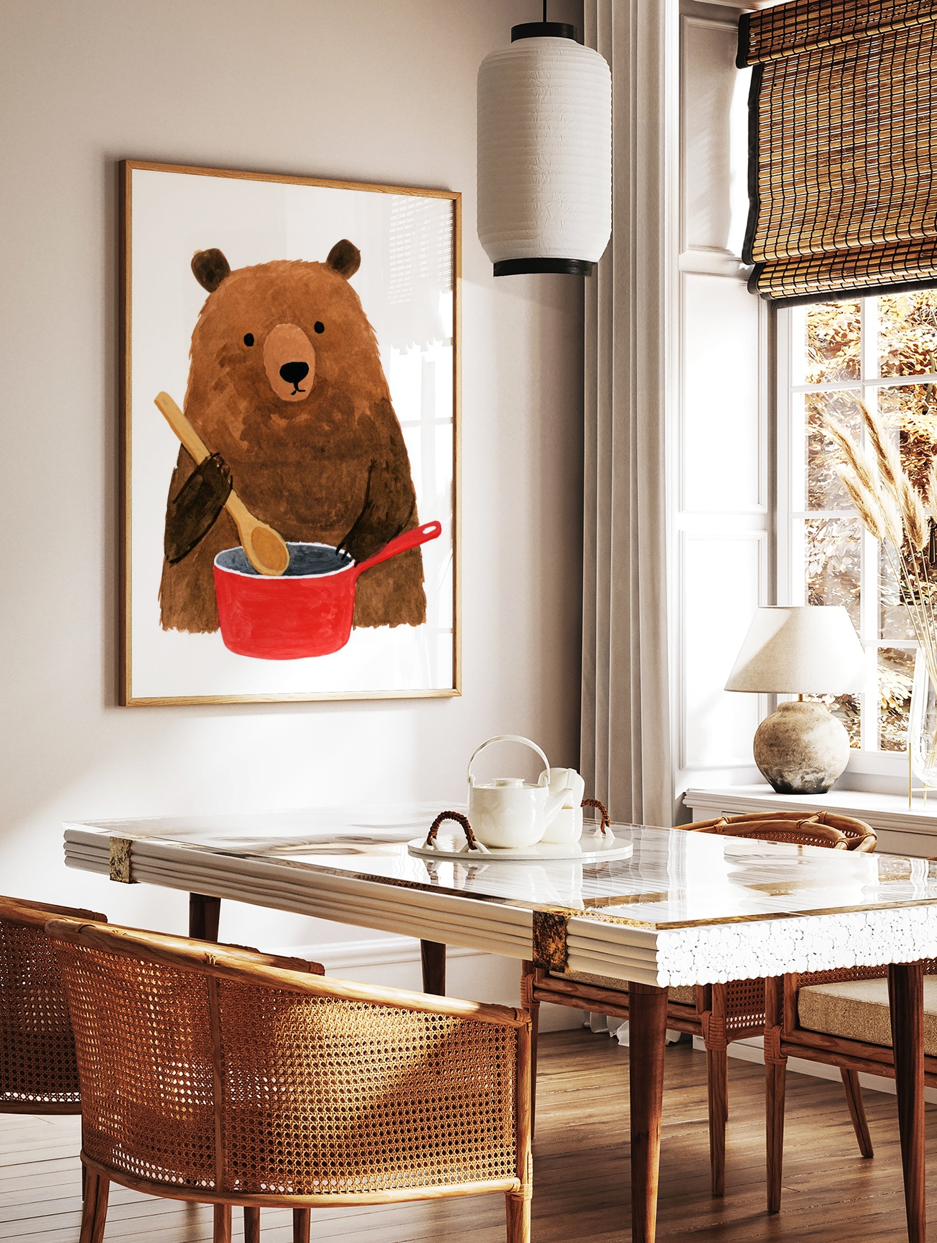 Brown bear holding a wooden spoon while cooking in a red pot illustration wall art print, in a styled room mockup