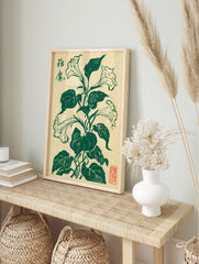 Brugmansia flower botanical illustration in deep green ink on cream paper with Japanese, in an alternate framed mockup