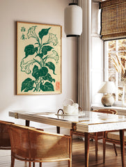 Brugmansia flower botanical illustration in deep green ink on cream paper with Japanese calligraphy, in a styled room mockup