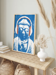 Illustrative print of a Buddha statue wearing headphones in blue and white on a textured, in an alternate framed mockup