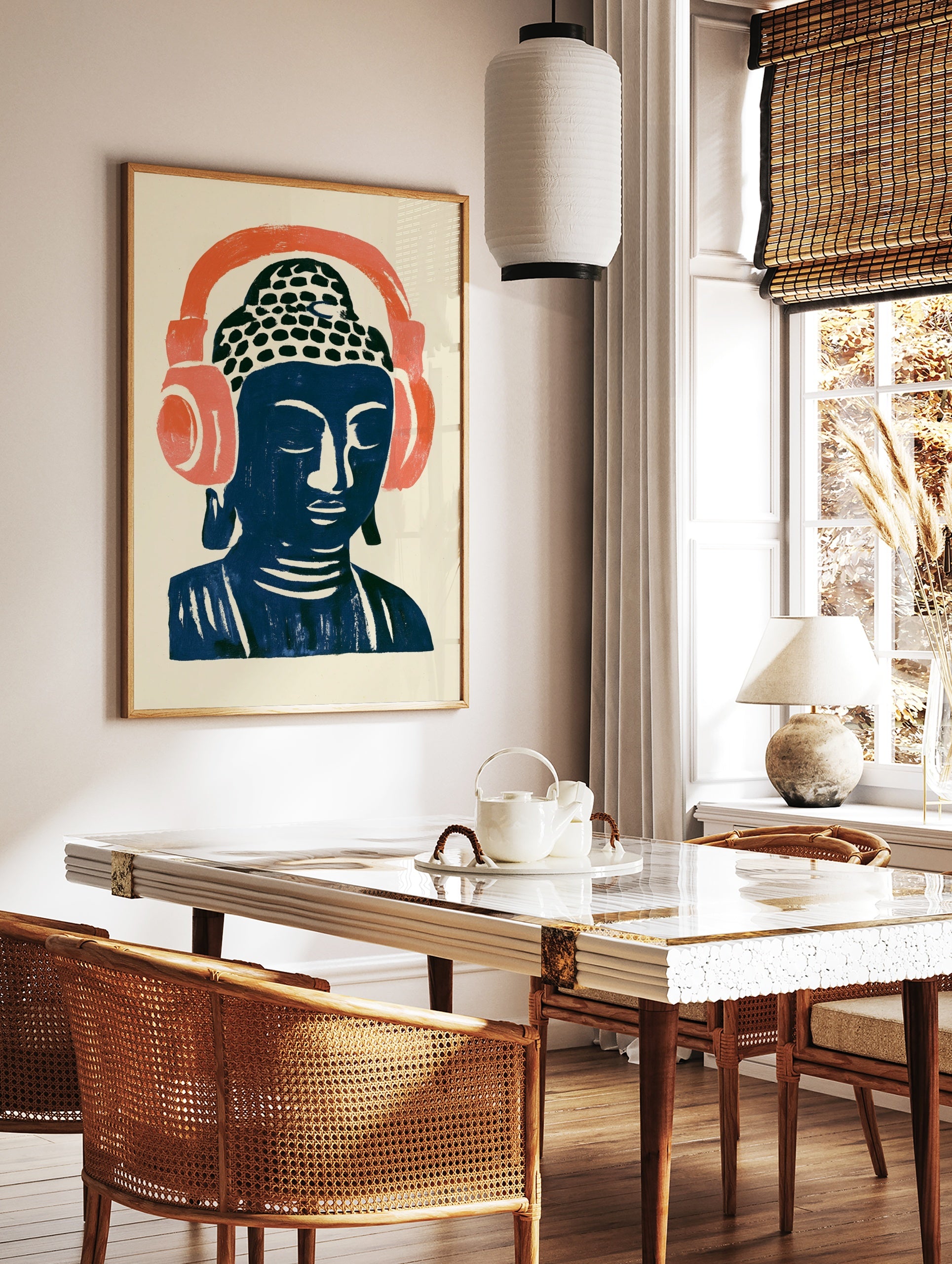 Stylized Buddha head illustration wearing large coral headphones on a cream background, modern, in a styled room mockup