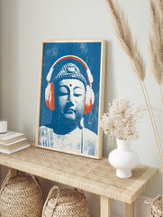 Buddha head illustration wearing large orange headphones on a textured blue background, pop, in an alternate framed mockup