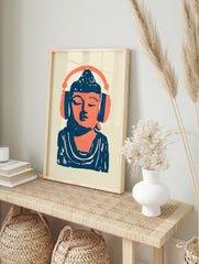 Stylized illustration of Buddha wearing headphones in vibrant orange and deep blue on a cream, in an alternate framed mockup