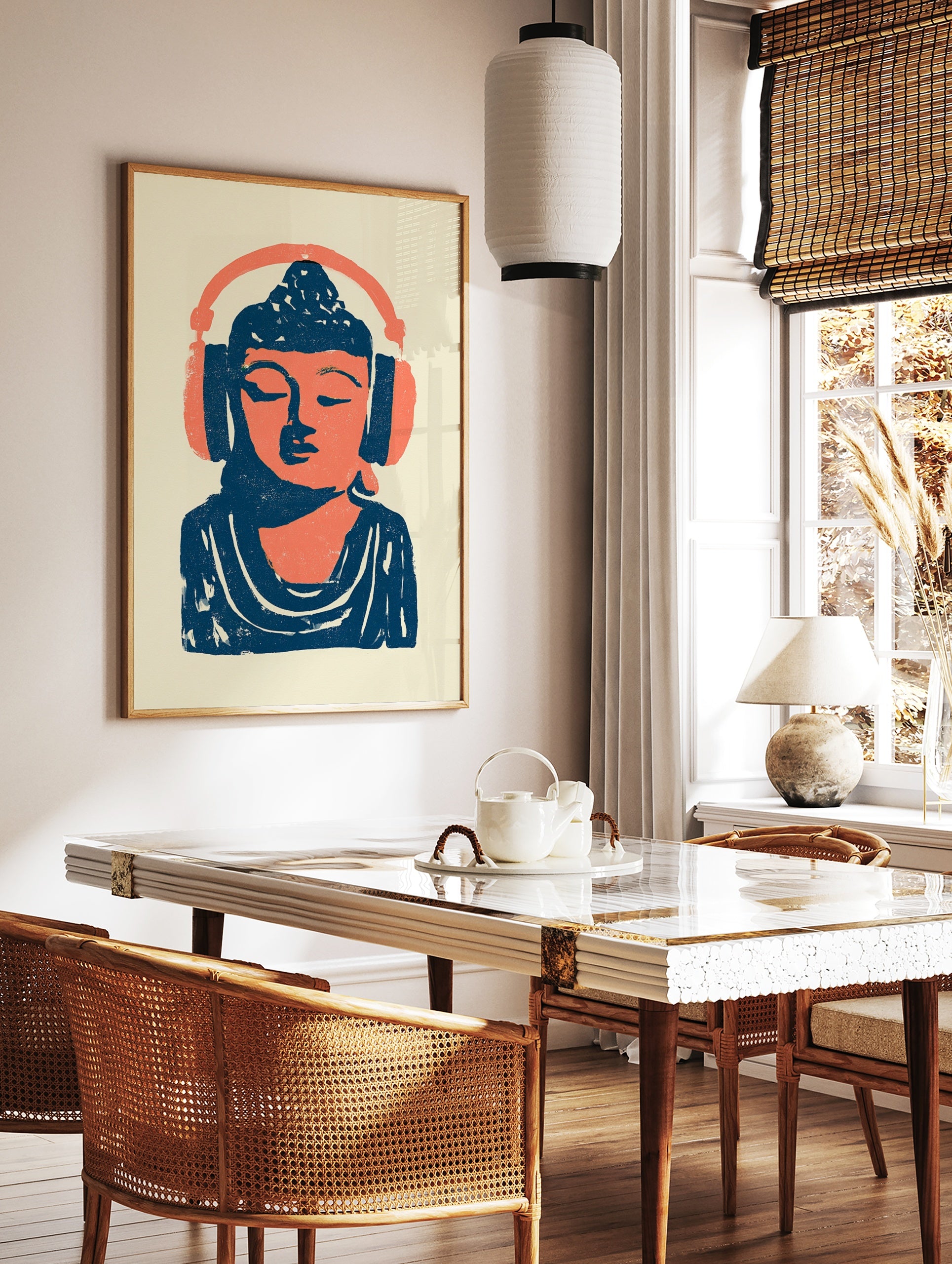 Stylized illustration of Buddha wearing headphones in vibrant orange and deep blue on a cream, in a styled room mockup