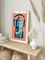 Stylised blue Buddha bust wearing large navy headphones on a coral pink background, in an alternate framed mockup