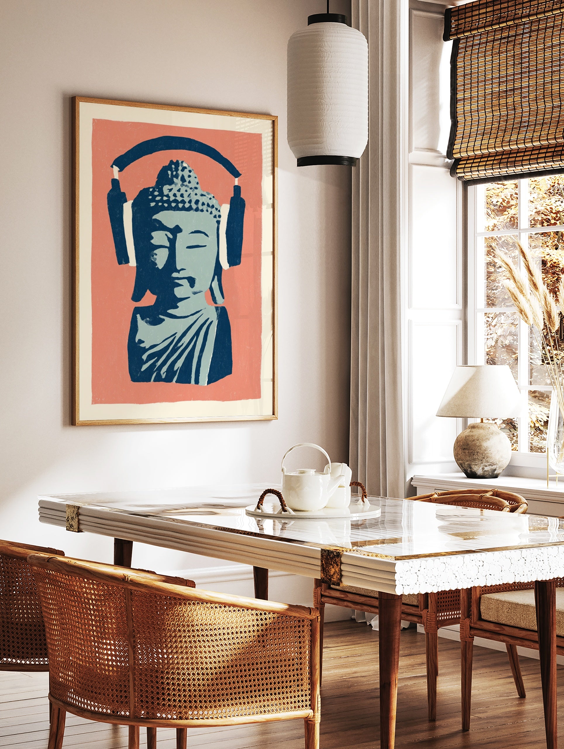 Stylised blue Buddha bust wearing large navy headphones on a coral pink background, illustrative, in a styled room mockup