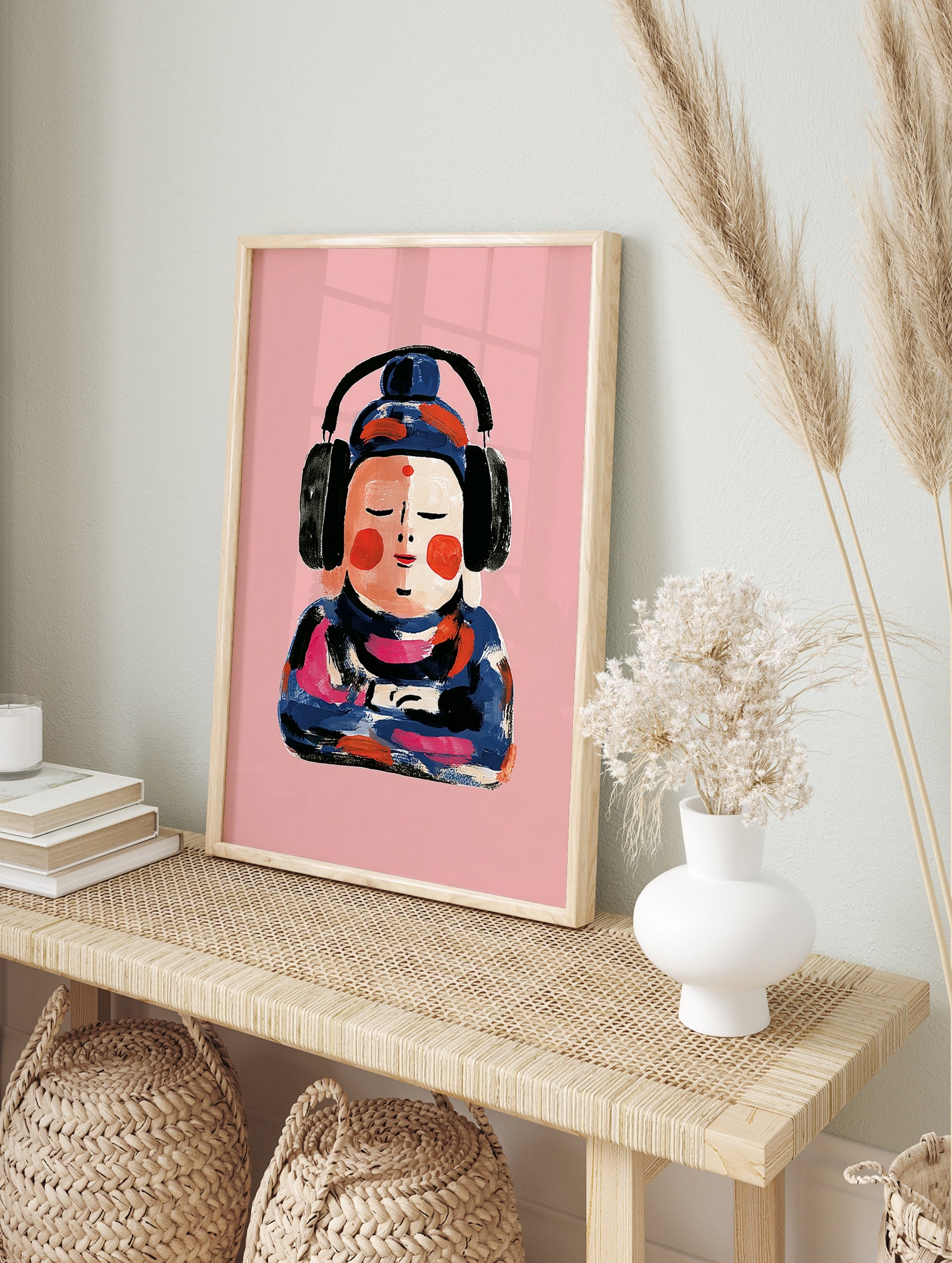 Painterly illustration of a Buddha figure wearing black headphones against a solid pink, in an alternate framed mockup