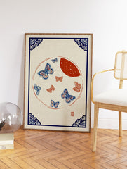 Traditional blue and red butterfly wall art print with a moon and ornate blue corner borders on a light background. - Image 2
