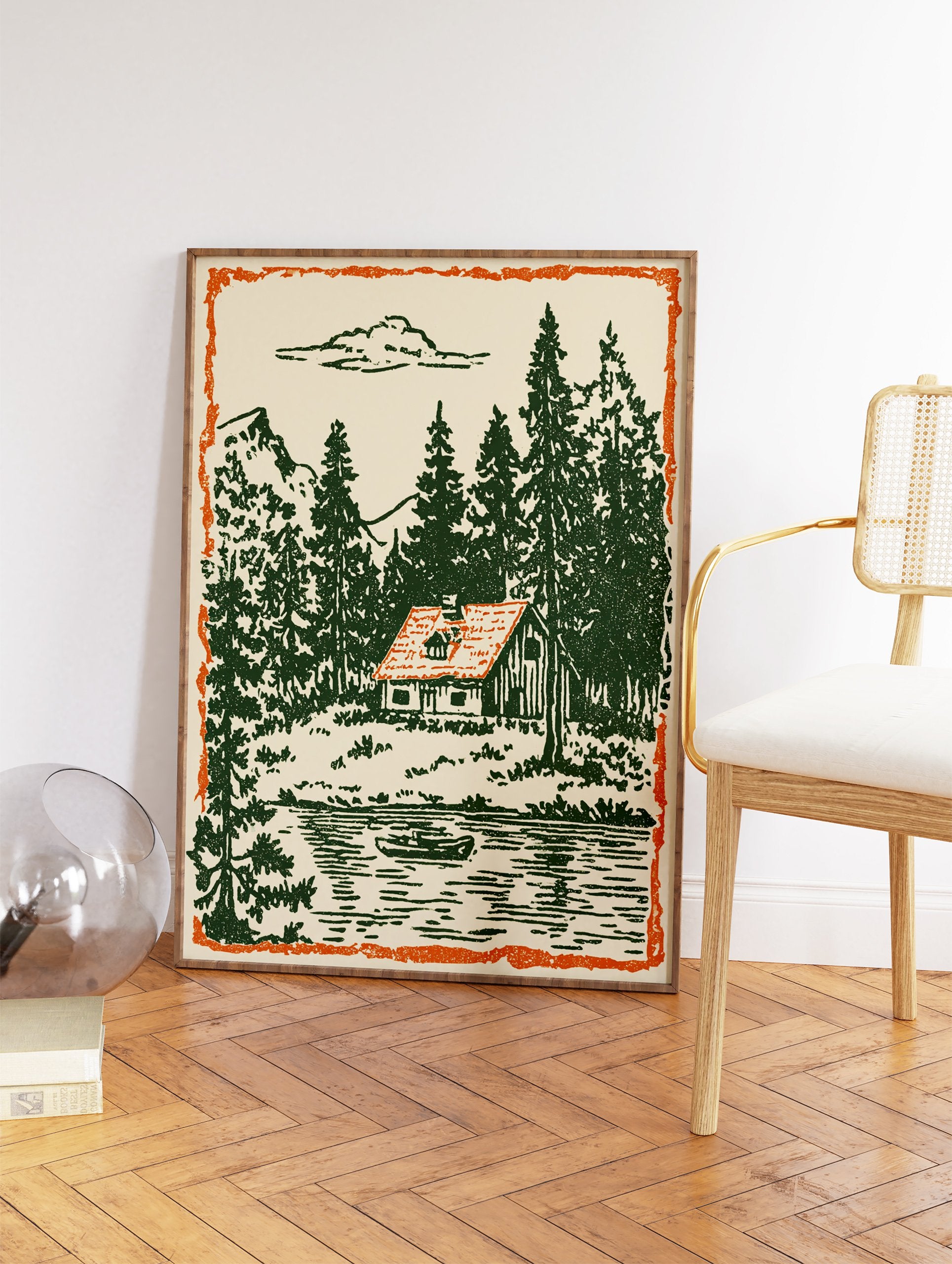 Vintage illustration of a cabin by a lake with green pine trees, mountains, and an orange border. - Image 2