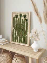 Illustrative botanical wall art print featuring tall green cacti with ribbed textures on a, in an alternate framed mockup
