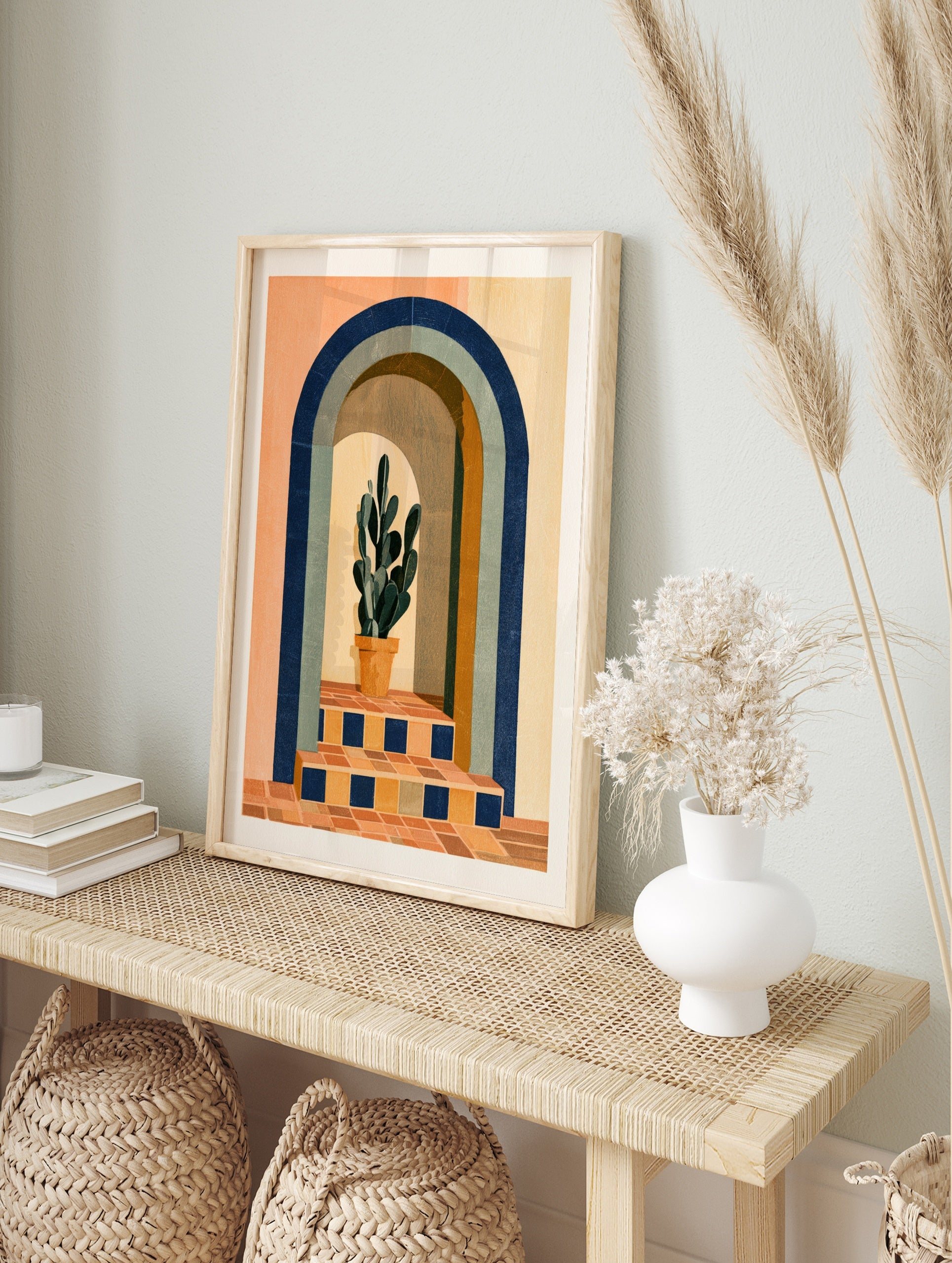Modern wall art print of a potted cactus inside a blue arched doorway with terracotta tiled, in an alternate framed mockup