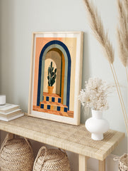 Modern wall art print of a potted cactus inside a blue arched doorway with terracotta tiled, in an alternate framed mockup