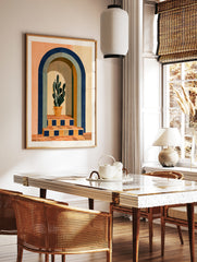 Modern wall art print of a potted cactus inside a blue arched doorway with terracotta tiled stairs, in a styled room mockup