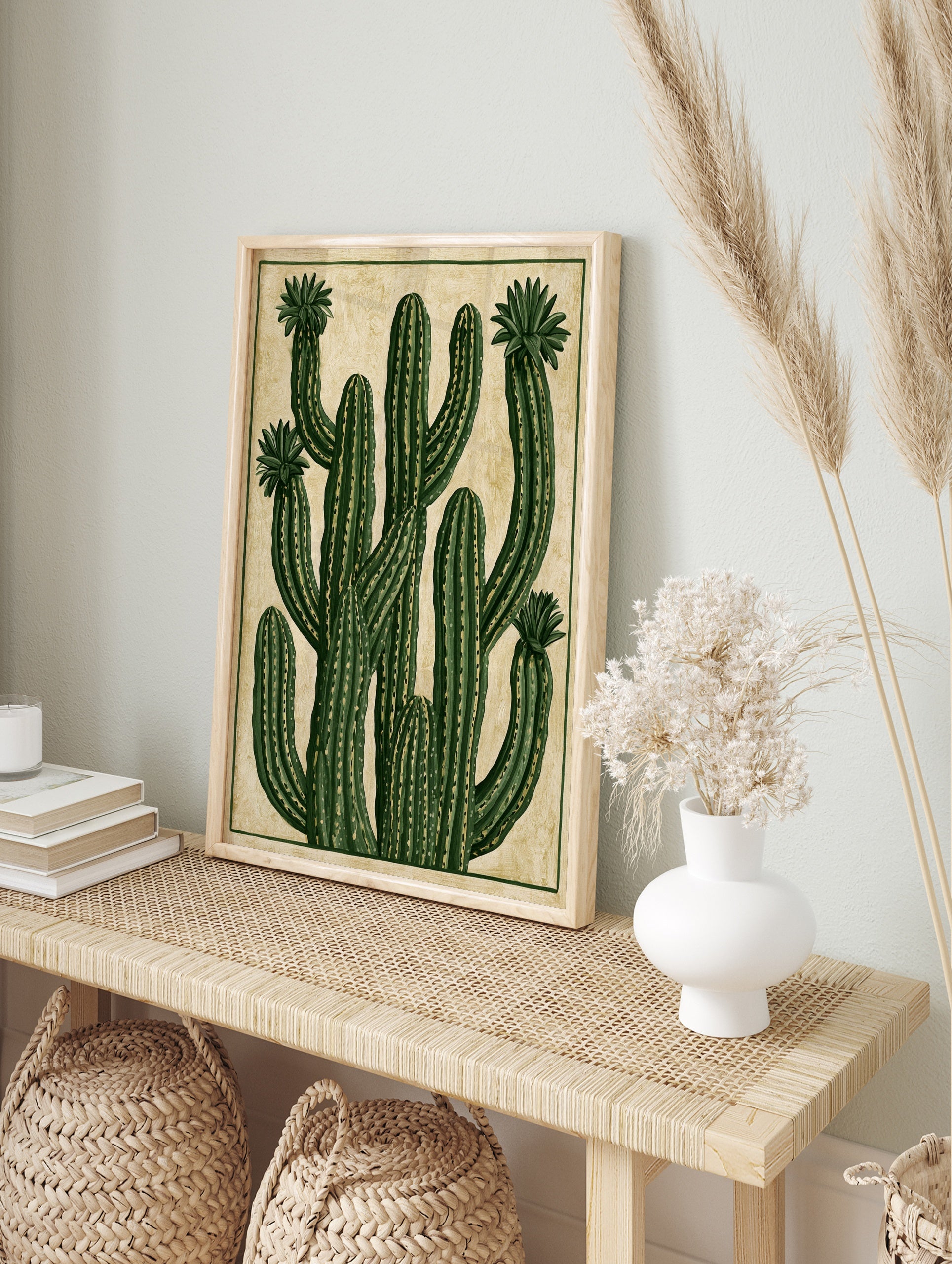 Stylised green cactus illustration with blooming flowers on a textured tan background, in an alternate framed mockup